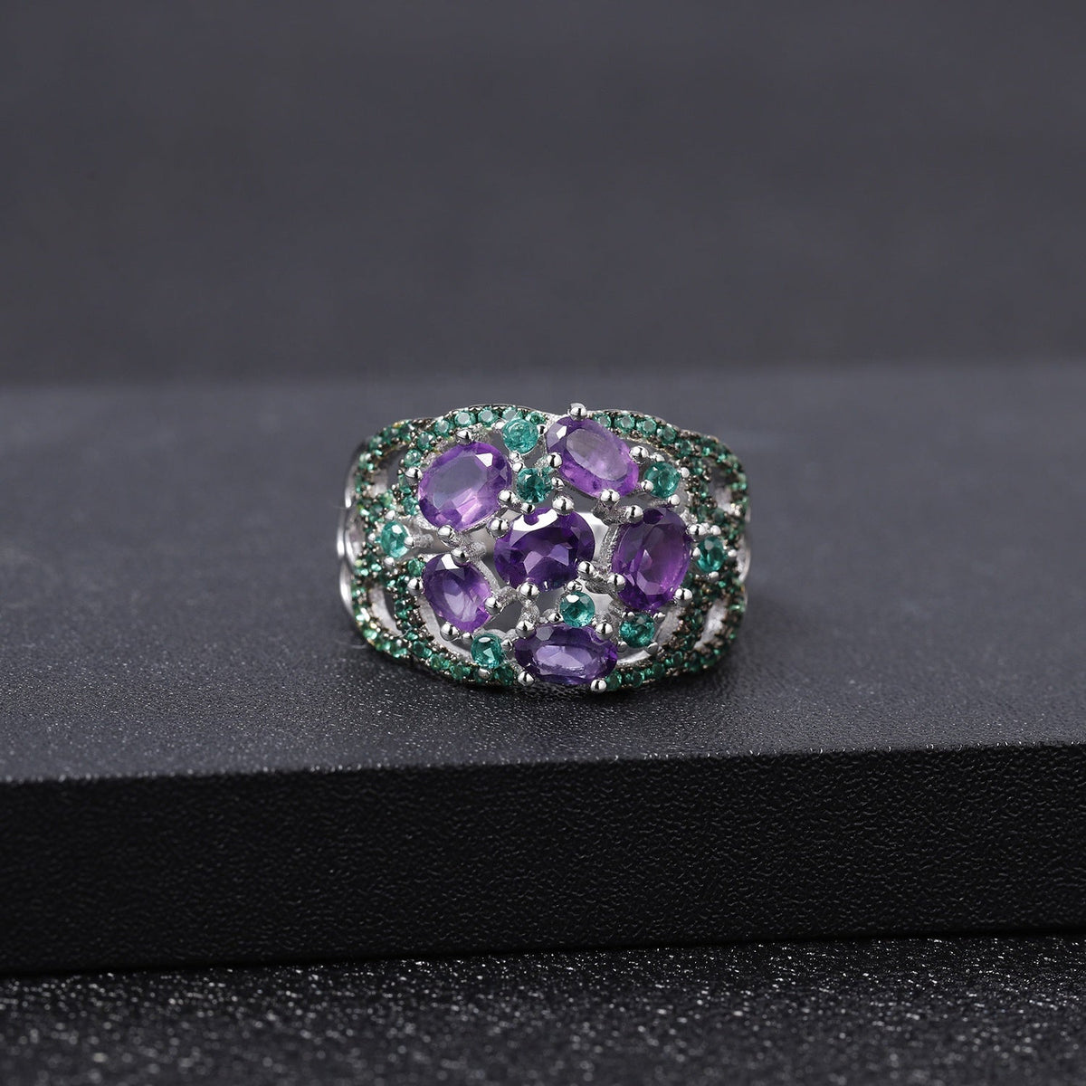Amethyst ring with green accent stones, carried for courage