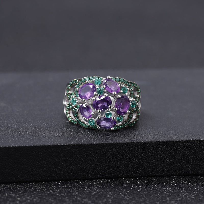 Amethyst ring with green accent stones, carried for courage